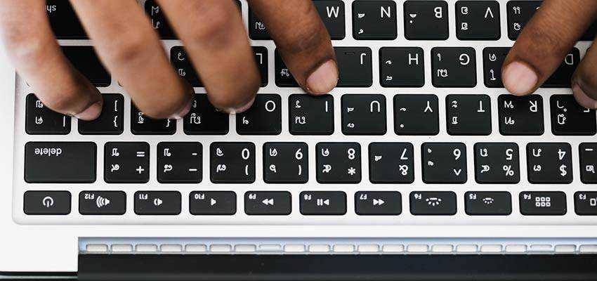 Person typing on a keyboard.