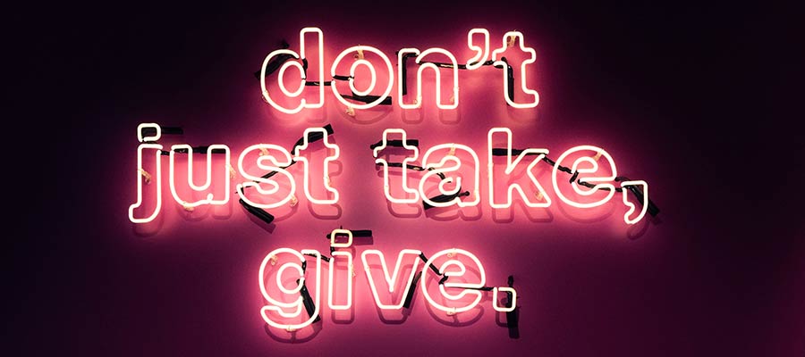 A sign that reads: "Don't just take, give."