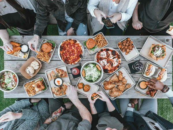 pizza table selection chicken people eating dinner outside food photography inspiration